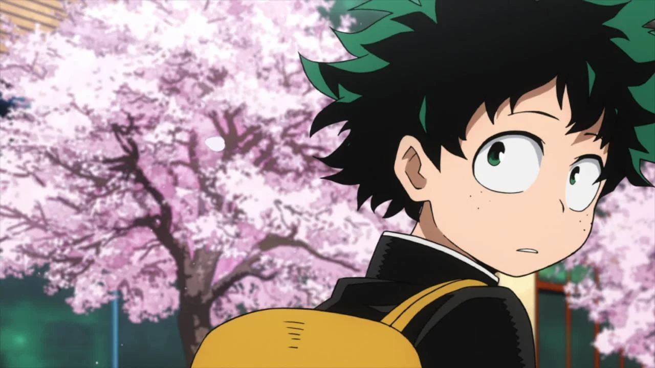 Izuku Midoriya en uniforme de collège devant des cerisiers en fleurs dans le premier épisode de My Hero Academia